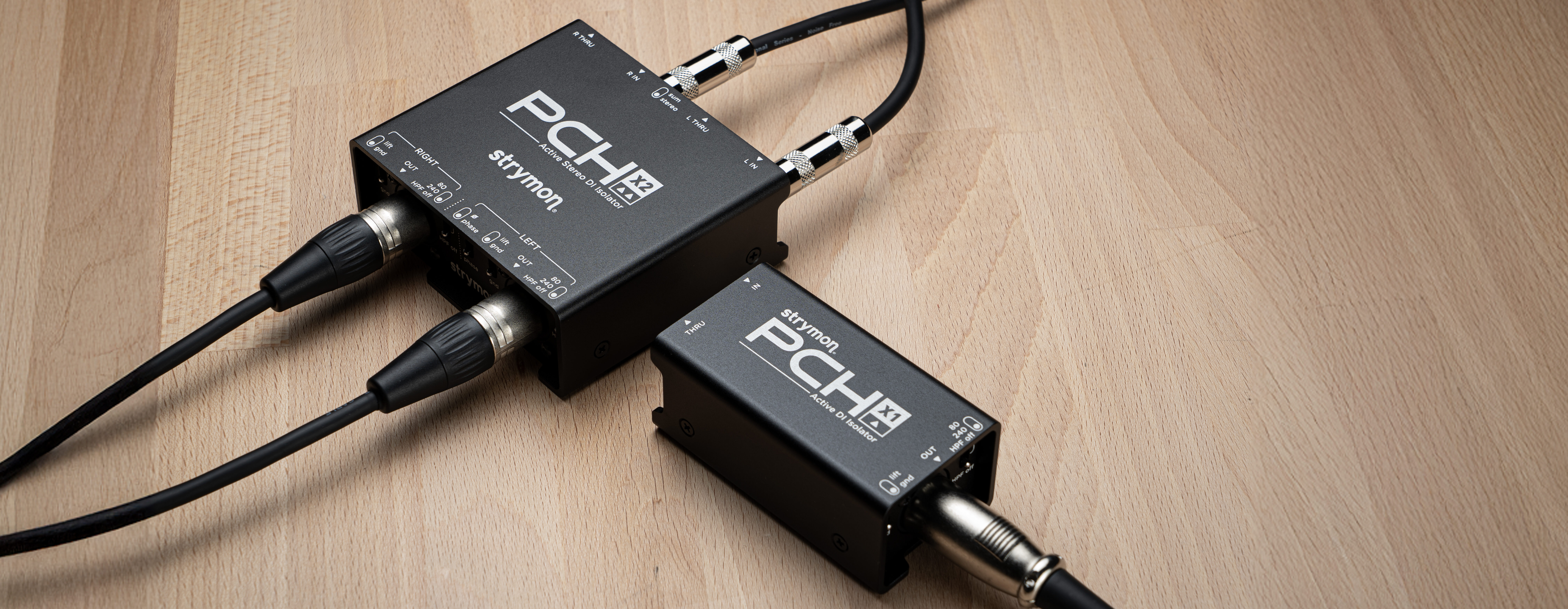 PCH X1 and X2 sitting on top of a wooden table.